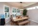 Cozy dining area with modern lighting and large windows that brighten the space at 3727 Wild Blossom Pl, Parrish, FL 34219
