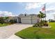 Lovely single-story home with a three-car garage, paver driveway, manicured lawn and an American flag at 3727 Wild Blossom Pl, Parrish, FL 34219