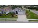 Well-manicured exterior of home with a paved driveway, three-car garage, and lush landscaping at 3727 Wild Blossom Pl, Parrish, FL 34219