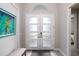 Foyer featuring plank floors, a gray bench, and a double front door with an arched transom window at 3727 Wild Blossom Pl, Parrish, FL 34219