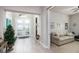 Foyer featuring plank floors, a gray bench, and a double front door with an arched transom window at 3727 Wild Blossom Pl, Parrish, FL 34219