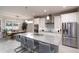 Bright kitchen with a large granite island, stainless steel appliances, and stylish pendant lighting at 3727 Wild Blossom Pl, Parrish, FL 34219