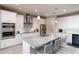 A beautifully designed kitchen with stainless steel appliances and a large center island with bar stool seating at 3727 Wild Blossom Pl, Parrish, FL 34219