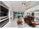 Elegant living room featuring a modern fireplace, large tv, and a comfortable, reclining leather sofa at 3727 Wild Blossom Pl, Parrish, FL 34219