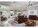 Spacious living room featuring modern furnishings, a ceiling fan, and flows into the kitchen at 3727 Wild Blossom Pl, Parrish, FL 34219