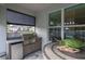 The outdoor kitchen has a built-in grill, sink, mini fridge, and bar, perfect for entertaining guests at 3727 Wild Blossom Pl, Parrish, FL 34219