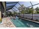 Screened-in pool with fountains and poolside seating provides a relaxing and private outdoor oasis at 3727 Wild Blossom Pl, Parrish, FL 34219