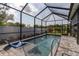 The screened-in pool includes a relaxing lounge chair area and a tranquil fountain feature at 3727 Wild Blossom Pl, Parrish, FL 34219