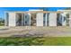 Well-maintained condo building with black exterior staircases, a parking lot, and lawn at 3823 N Oak Dr # K22, Tampa, FL 33611