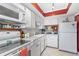 Well-lit kitchen with white appliances, countertops, and cabinetry, offering a clean and functional space at 3823 N Oak Dr # K22, Tampa, FL 33611