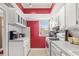 Bright, galley-style kitchen features white appliances, ample counter space, and a window for natural light at 3823 N Oak Dr # K22, Tampa, FL 33611