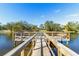 Scenic view of a wooden dock extending into a serene lake on a clear, sunny day at 3823 N Oak Dr # K22, Tampa, FL 33611