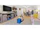 Open-concept living space with hardwood floors, modern furnishings, and seamless flow to dining area at 3823 N Oak Dr # K22, Tampa, FL 33611