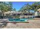 Community pool with lounge chairs, mature landscaping, and multi-story condo buildings in the background at 3823 N Oak Dr # K22, Tampa, FL 33611