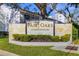 Fair Oaks Condominiums signage, landscaping, with building exterior elements are visible on a sunny day at 3823 N Oak Dr # K22, Tampa, FL 33611