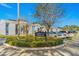 Community entrance sign for Ashwood Square with lush landscaping and condo buildings in the background at 3823 N Oak Dr # K22, Tampa, FL 33611