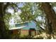 Exterior of blue barn surrounded by trees and natural scenery with a wooden lower section at 3940 E Knights Griffin Rd, Plant City, FL 33565