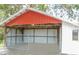 Open barn featuring a metal roof and a chained gate in front at 3940 E Knights Griffin Rd, Plant City, FL 33565
