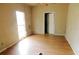Bedroom featuring laminate floors, white walls, and one window at 3940 E Knights Griffin Rd, Plant City, FL 33565