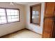 Bedroom with wood trim windows, beige walls, and laminate floors at 3940 E Knights Griffin Rd, Plant City, FL 33565