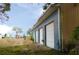 Metal building exterior features three large garage doors at 3940 E Knights Griffin Rd, Plant City, FL 33565