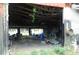 Interior of a metal building with exposed rafters, containing equipment and other miscellaneous contents at 3940 E Knights Griffin Rd, Plant City, FL 33565