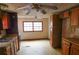 Kitchen with wooden cabinets and vintage ceiling fans at 3940 E Knights Griffin Rd, Plant City, FL 33565