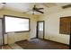 Bright living room with a large window and an open doorway at 3940 E Knights Griffin Rd, Plant City, FL 33565