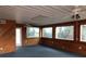 Bright sun room with wood paneling, large windows, and ceiling fans at 3940 E Knights Griffin Rd, Plant City, FL 33565