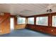 Bright sunroom featuring wood paneling, large windows, and two ceiling fans at 3940 E Knights Griffin Rd, Plant City, FL 33565