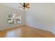 Bright bedroom features wood floors, neutral paint, and a large window offering natural light at 402 Laurel Lake Dr # 104, Venice, FL 34292