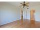 Bedroom featuring wood floors, a ceiling fan, and two doorways at 402 Laurel Lake Dr # 104, Venice, FL 34292