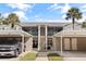 View of the building exterior with covered parking and screened in patios at 402 Laurel Lake Dr # 104, Venice, FL 34292