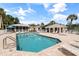 Inviting community pool with ample seating, lounge chairs, and nearby clubhouse facilities at 402 Laurel Lake Dr # 104, Venice, FL 34292