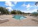 Relaxing community pool with lounge chairs, umbrellas, and manicured landscaping at 402 Laurel Lake Dr # 104, Venice, FL 34292