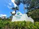 Waterside Village sign surrounded by lush landscaping against a bright blue sky with scattered clouds at 402 Laurel Lake Dr # 104, Venice, FL 34292