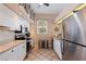 Efficient kitchen featuring white cabinets, stainless steel appliances, and neutral countertops at 402 Laurel Lake Dr # 104, Venice, FL 34292