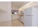 Kitchen features white cabinets and appliances, bright and well maintained at 402 Laurel Lake Dr # 104, Venice, FL 34292