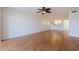 Open living room with wood floors, ceiling fan, and adjacent dining area with chandelier at 402 Laurel Lake Dr # 104, Venice, FL 34292