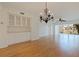 Spacious living room with wood flooring, chandelier and lake view at 402 Laurel Lake Dr # 104, Venice, FL 34292