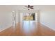 Bright living room featuring wood floors, a ceiling fan, and sliding glass doors to a scenic view at 402 Laurel Lake Dr # 104, Venice, FL 34292