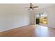 Bright living room featuring wood floors and sliding glass doors to a scenic view at 402 Laurel Lake Dr # 104, Venice, FL 34292