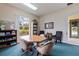 Bright meeting room providing the perfect space for quiet gatherings, games, and relaxation with bookshelf and reading material at 402 Laurel Lake Dr # 104, Venice, FL 34292