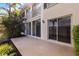 A private patio with stucco walls, and large windows offering an outdoor view at 402 Laurel Lake Dr # 104, Venice, FL 34292