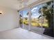 The sunroom features tile floors and large windows with views of the water at 402 Laurel Lake Dr # 104, Venice, FL 34292