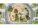 Aerial view of community park featuring playground equipment, a basketball court, and paved walking paths at 4094 Windcrest Dr, Wesley Chapel, FL 33544