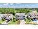 Two-story home with stone accents, a three-car garage, and manicured lawn nestled in a lush community at 4094 Windcrest Dr, Wesley Chapel, FL 33544