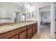 A spacious bathroom featuring double vanity, and a view into the bedrooom at 4094 Windcrest Dr, Wesley Chapel, FL 33544