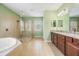 Modern bathroom featuring a large glass shower, separate tub, and a vanity with a mirror at 4094 Windcrest Dr, Wesley Chapel, FL 33544