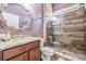 Modern bathroom featuring stylish vanity, decorative mirror, and a frameless glass shower with tiled walls at 4094 Windcrest Dr, Wesley Chapel, FL 33544